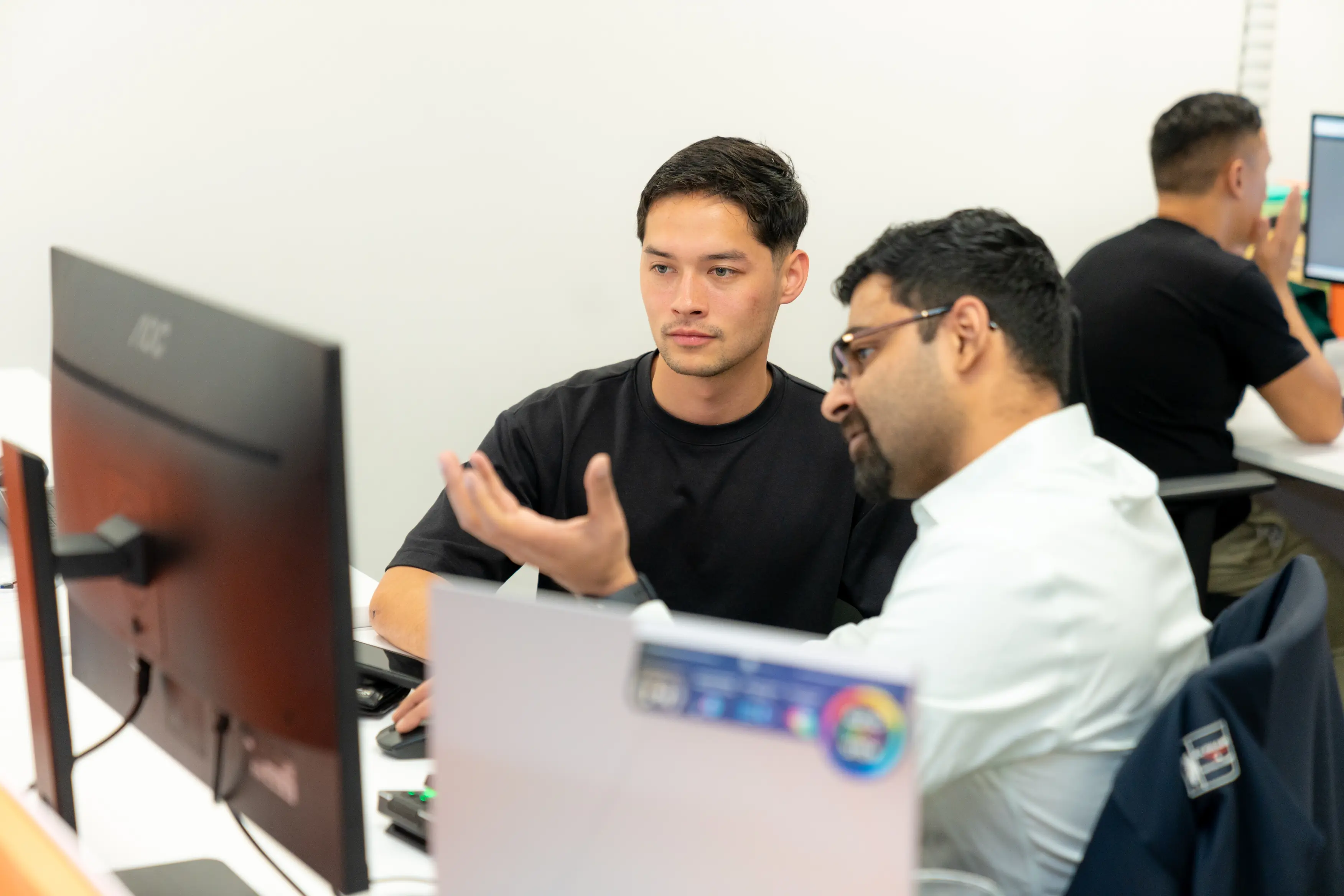 Award-Winning SEO Agency, two men looking at a computer screen discussing SEO