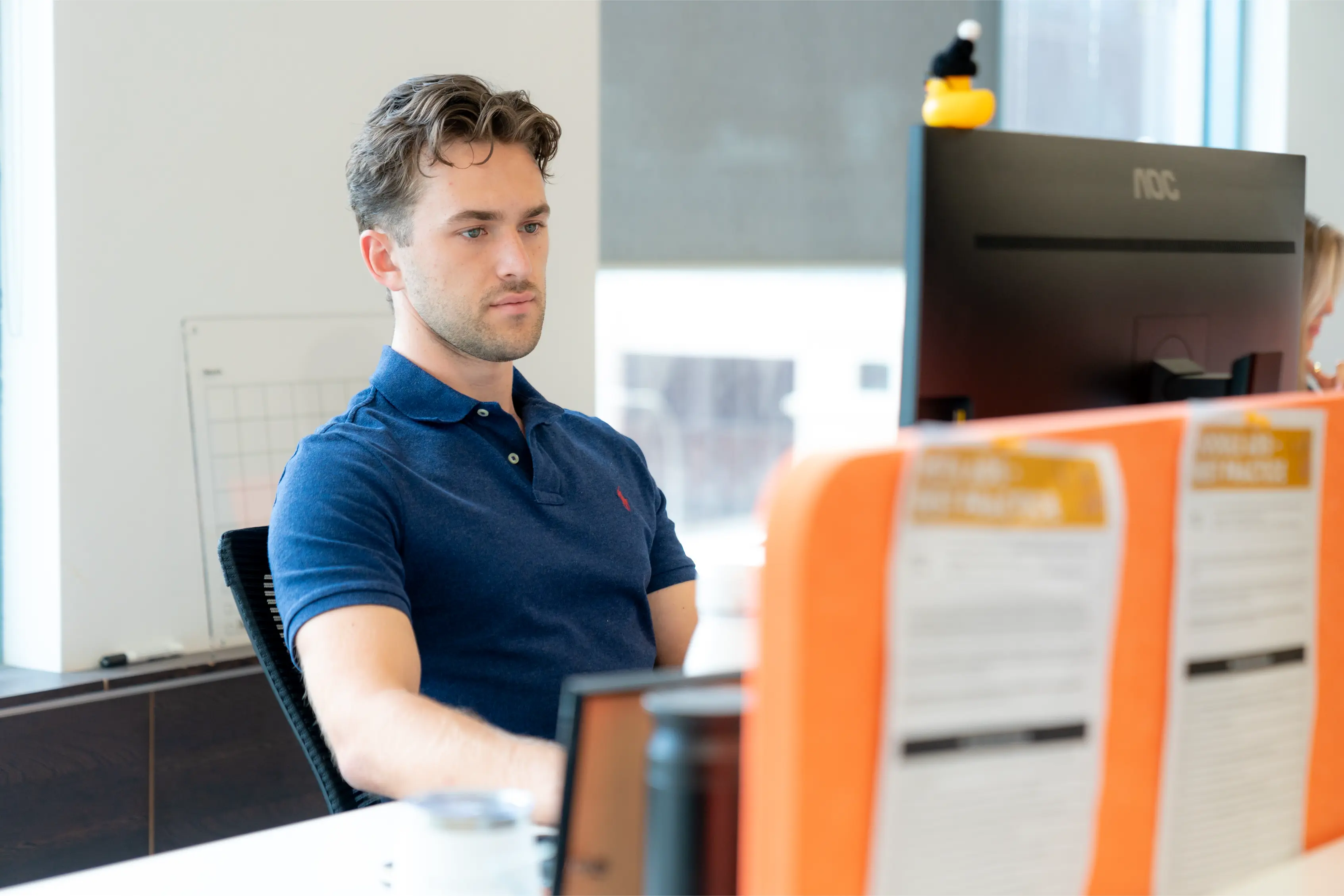 Leading AdWords Agency, man sitting in a chair at a desk, working at a computer